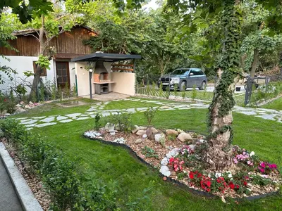 a backyard with a garden with flowers and a house at Villa Sea House in Byala