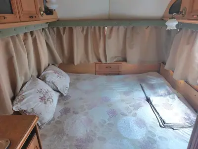 a small bed in the back of a rv at Каравана Summer time in Chernomorets