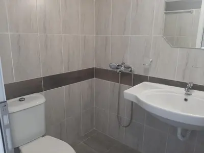 a bathroom with a toilet and a sink at Апартаменти Жени in Tsarevo