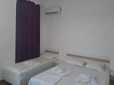 two beds sitting next to each other in a room at Апартаменти Жени in Tsarevo