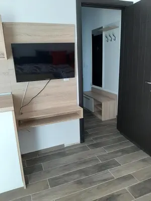 a room with a television and a tiled floor at Апартаменти Жени in Tsarevo