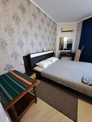 a bedroom with a bed and a table in it at Apartment with sea view in Sunny Beach