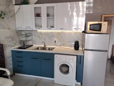 a kitchen with a sink and a washing machine at Apartment with sea view in Sunny Beach