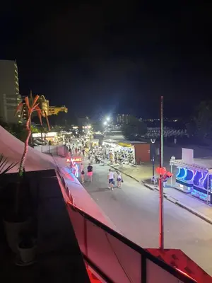 a group of people walking on a beach at night at Apartment with sea view in Sunny Beach