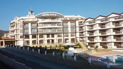 a large white building with a swimming pool in front of it at LaRaMi Studio in Sveti Vlas