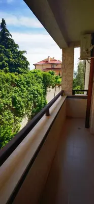 a balcony of a building with a view of trees at LaRaMi Studio in Sveti Vlas