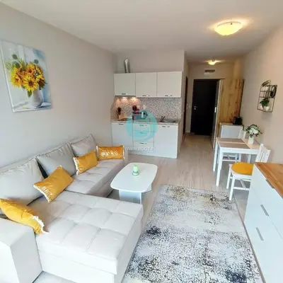 a living room with a white couch and a table at U Dacha - Premium Apartments in Sunny Beach