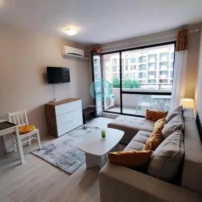 a living room with a couch and a table at U Dacha - Premium Apartments in Sunny Beach