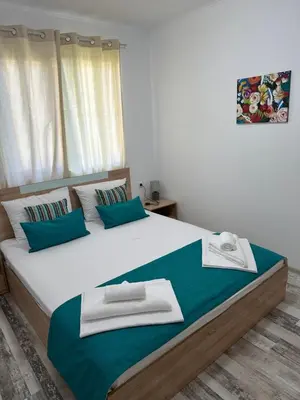 a bedroom with a large bed with green and white pillows at Villa Sea House 2 in Byala