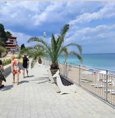 a group of people walking on a sidewalk near the beach at Villa Sea House 2 in Byala