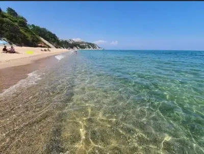 a beach with clear water and people on the beach at Villa Sea House 2 in Byala