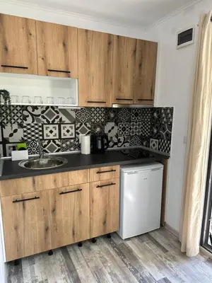 a kitchen with wooden cabinets and a sink at Villa Sea House 3 in Byala