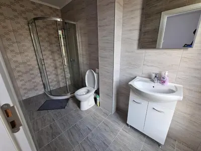 a bathroom with a toilet and a sink and a shower at Premium 2 bedroom flat at Millennium 2 in Sveti Vlas
