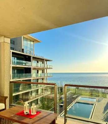 a balcony with a table and a view of the ocean at Sea view Penthouse (YooBulgaria) in Obzor