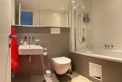 a bathroom with a toilet and a sink and a shower at Sea view Penthouse (YooBulgaria) in Obzor