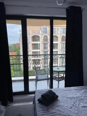 a bedroom with a bed and a view of a balcony at Villa Astoria 5. Sveti Vlas k.k. Elenite in Sveti Vlas