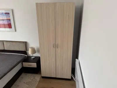 a bedroom with a cupboard and a bed at Panoramic Sea View Apartment in Byala