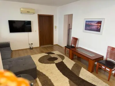 a living room with a couch and a table at Panoramic Sea View Apartment in Byala
