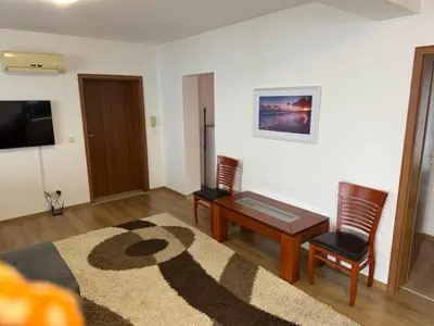 a living room with a table and two chairs at Panoramic Sea View Apartment in Byala