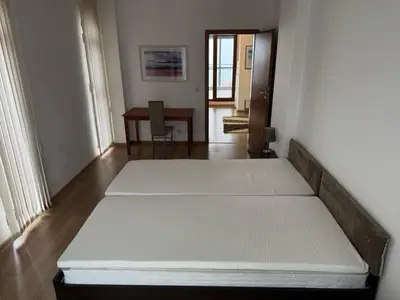 a room with a bed and a desk in it at Panoramic Sea View Apartment in Byala