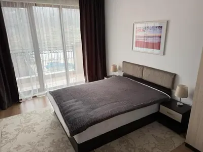 a bedroom with a bed and a large window at Panoramic Sea View Apartment in Byala