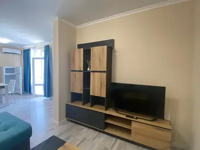a living room with a flat screen tv on a entertainment center at MARINA BAY 23 Sveti Vlas Beach in Sveti Vlas