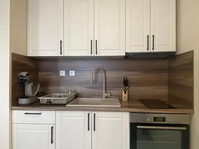 a kitchen with white cabinets and a sink at MARINA BAY 23 Sveti Vlas Beach in Sveti Vlas