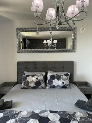 a bedroom with a bed with a large mirror at k.k Elenite Vila Astoria 5 in Sveti Vlas