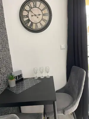 a table with wine glasses and a clock on the wall at k.k Elenite Vila Astoria 5 in Sveti Vlas