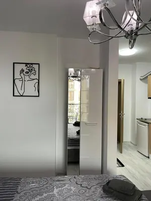 a bedroom with a mirror and a white refrigerator at k.k Elenite Vila Astoria 5 in Sveti Vlas