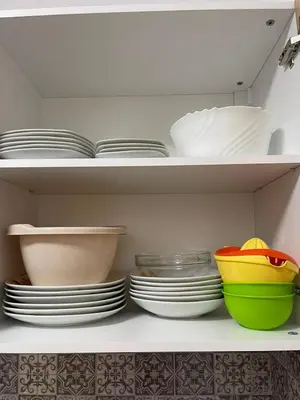 a white shelf with plates and bowls on it at k.k Elenite Vila Astoria 5 in Sveti Vlas