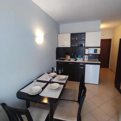 a kitchen with a table and chairs in a room at Sunset Beach 3 - Apartments in Sunny Beach