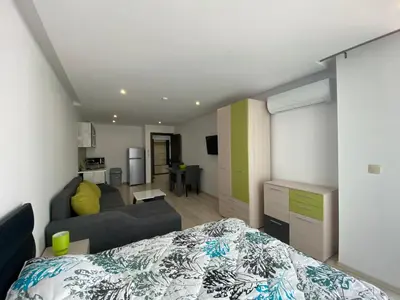 a bedroom with a bed and a living room at PARADISO 'В' 402 Private Apartment Nessebar in Nesebar