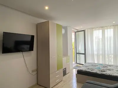 a bedroom with a bed and a flat screen tv at PARADISO 'В' 402 Private Apartment Nessebar in Nesebar