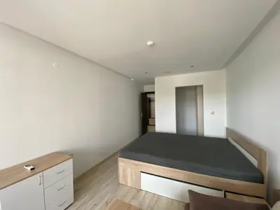 a bedroom with a bed in the corner of a room at PARADISO 'В' 402 Private Apartment Nessebar in Nesebar