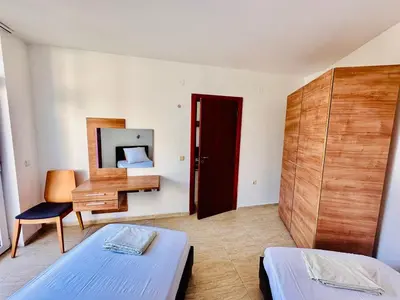 a bedroom with two beds and a desk and a mirror at Cozy Mood Two-bed flat in Sunny Beach in Sunny Beach