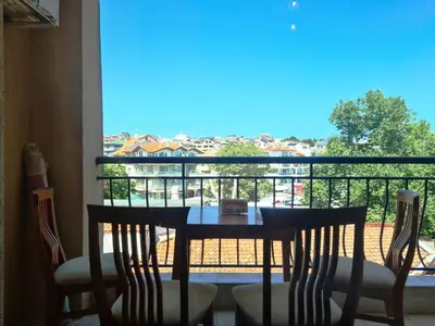 a table and chairs with a view of a balcony at апартамент под наем на първа линия море in Sozopol