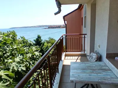 a balcony with a view of the ocean at Farlalievi Guest House in Sozopol