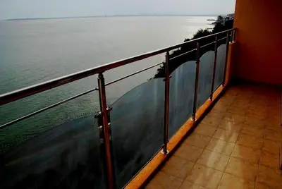 a balcony of a cruise ship looking out at the water at Coral Beach Apartment in Sveti Vlas