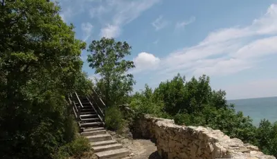 a set of stairs on top of a stone wall at Coral Beach Apartment in Sveti Vlas