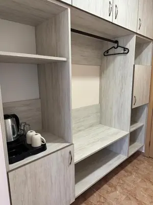 a kitchen with wooden cupboards with a kitchen utensils at Oleander House and Tennis Club in Sunny Beach