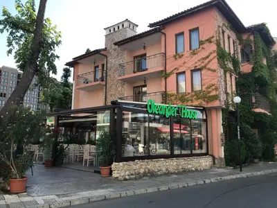 a store with a sign in front of a building at Oleander House and Tennis Club in Sunny Beach