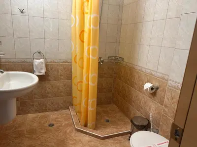 a bathroom with a shower with a sink and a toilet at Oleander House and Tennis Club in Sunny Beach