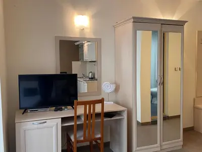 a room with a desk with a television and a chair at AVALON D202 Private Studio Sunny Beach in Sunny Beach