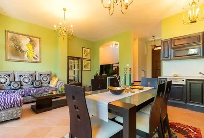 a kitchen and living room with a table and a couch at Luxury 2 bedroom villa in Sozopolis in Sozopol