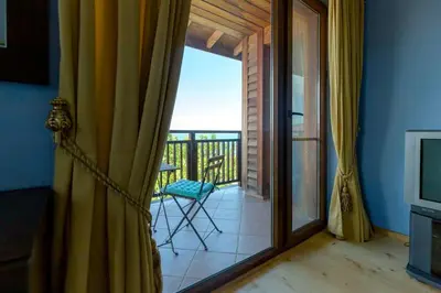 a room with a sliding glass door to a balcony at Luxury 2 bedroom villa in Sozopolis in Sozopol