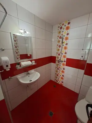 a bathroom with a sink and a toilet and a mirror at Guest Rooms Skalite in Sozopol