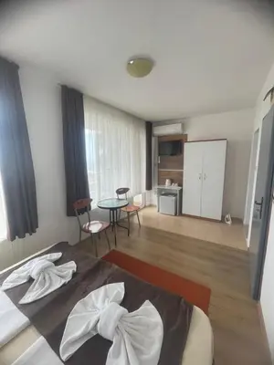 a bedroom with a bed and a table in a room at Свети Никола in Sozopol