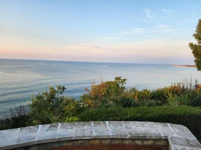 a view of the ocean from a stone bench at VALENCIA GARDENS STUDIO LUX 4 per. in Nesebar