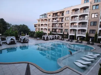 a large swimming pool in front of a building at VALENCIA GARDENS STUDIO LUX 4 per. in Nesebar